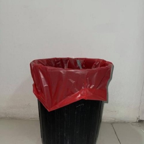 Red garbage bag fitted in a bin